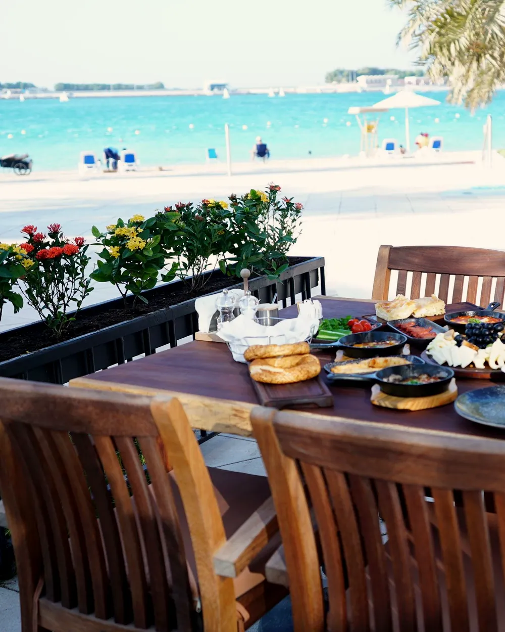 A bright café in Abu Dhabi with high wooden stools